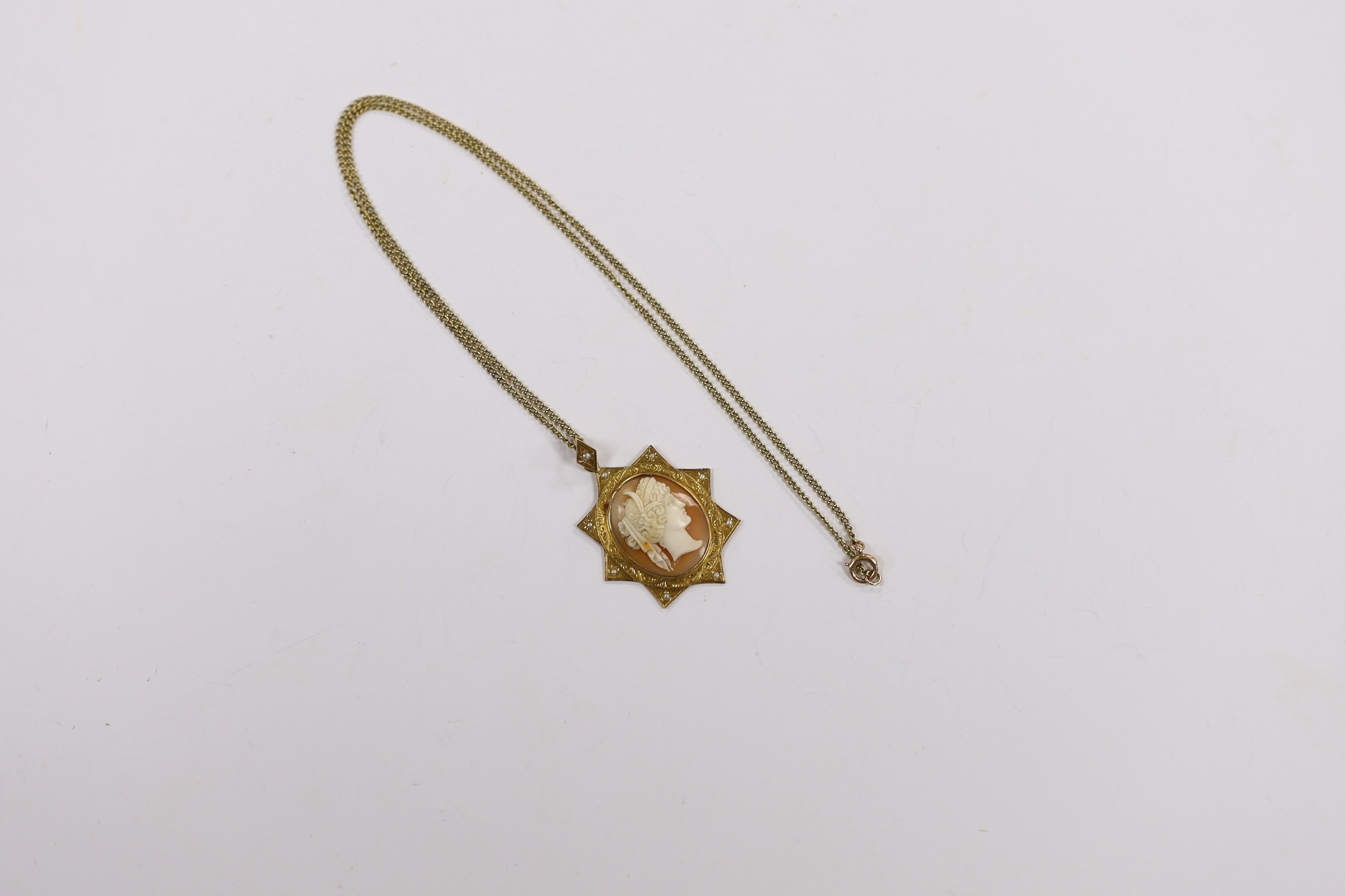A Victorian yellow metal and seed pearl set cameo shell pendant, 40mm on a 15ct fine link chain, 44cm, gross weight 9.1 grams.